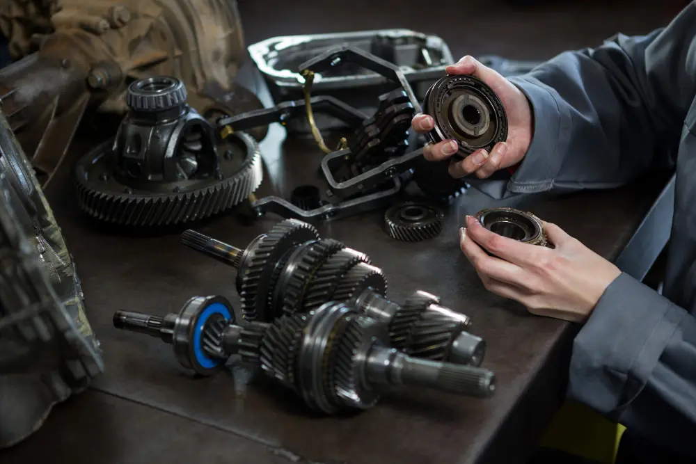 A Mechanic Holding Car Parts in His Hand